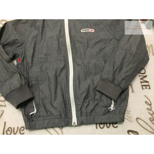 Next 7 év 122 cm  szürke - narancssárga szél és vízálló fiú átmeneti kabát/ széldzseki - újszerű, hibátlan